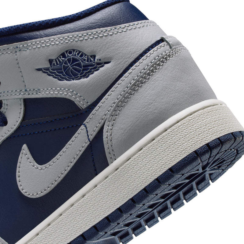 Close-up of youth mid-top sneaker side with Air Jordan Wings logo and navy swoosh