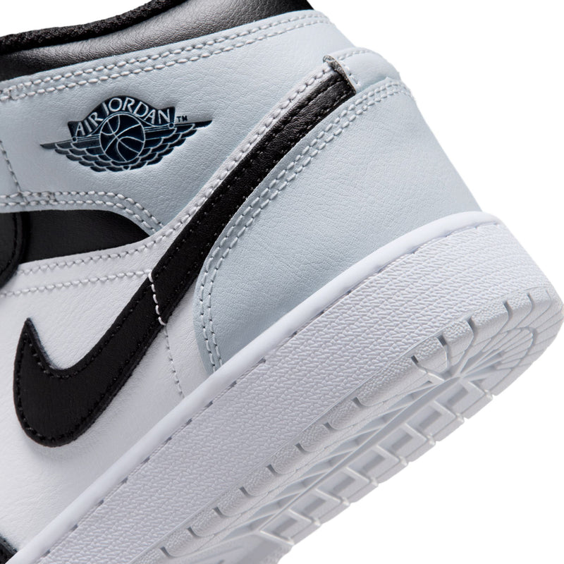 Youth high-top sneaker side panel close-up, wing logo, black swoosh, textured sole