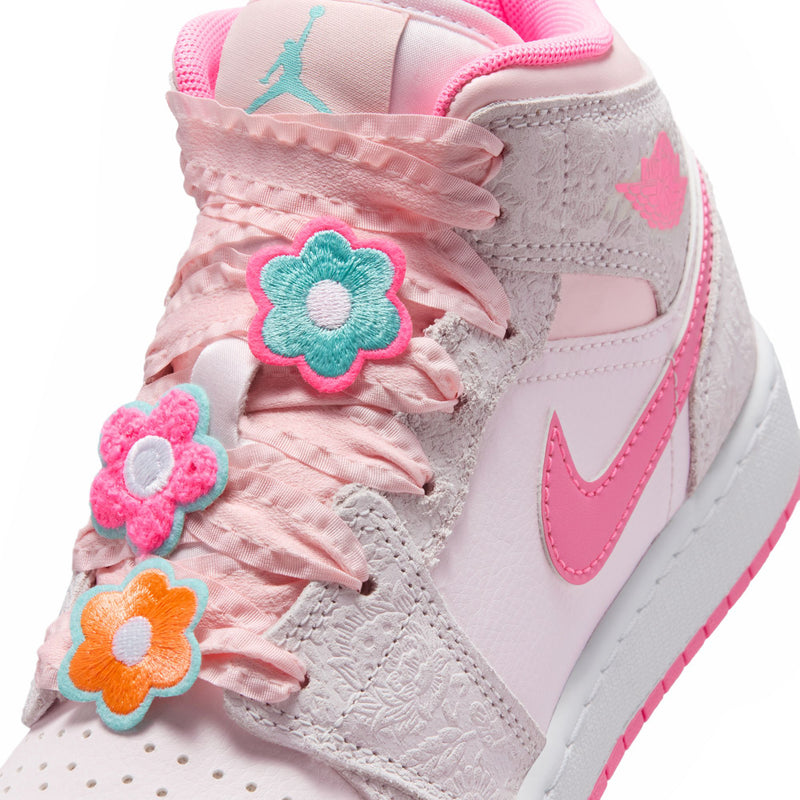 Youth mid-top sneakers detail: light gray upper with pink floral appliques on laces.