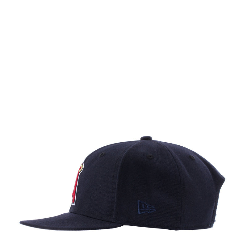Navy baseball cap, angled side view with small embroidered emblem