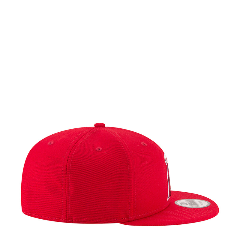 Red baseball cap with curved brim and ventilation eyelets