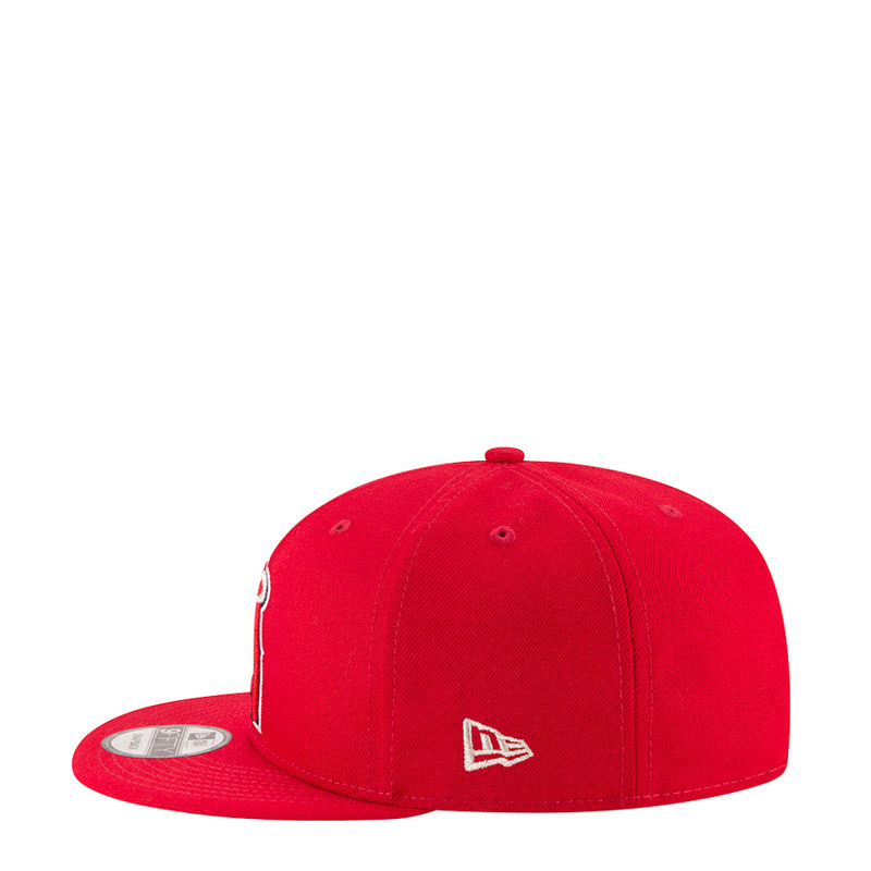 Red baseball cap with side logo patch and curved brim
