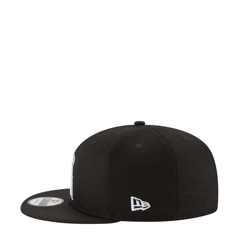 Black baseball cap with white small logo on front panel