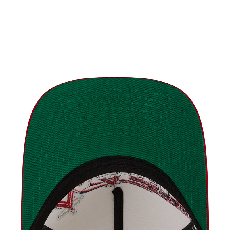 Baseball cap with green crown and black underbrim, mesh texture detail