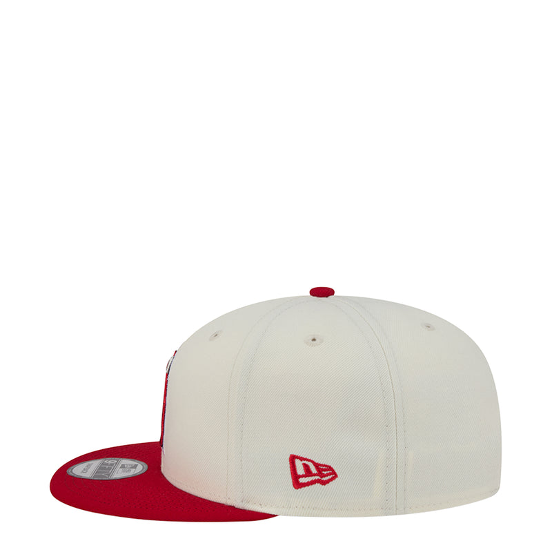 Two-tone baseball cap with white crown, red brim, small red A side logo