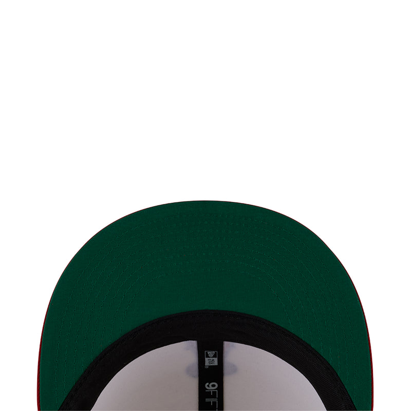 Baseball cap in dark green with black band detail