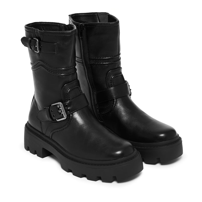 Pair of black leather boots with buckles on a white background