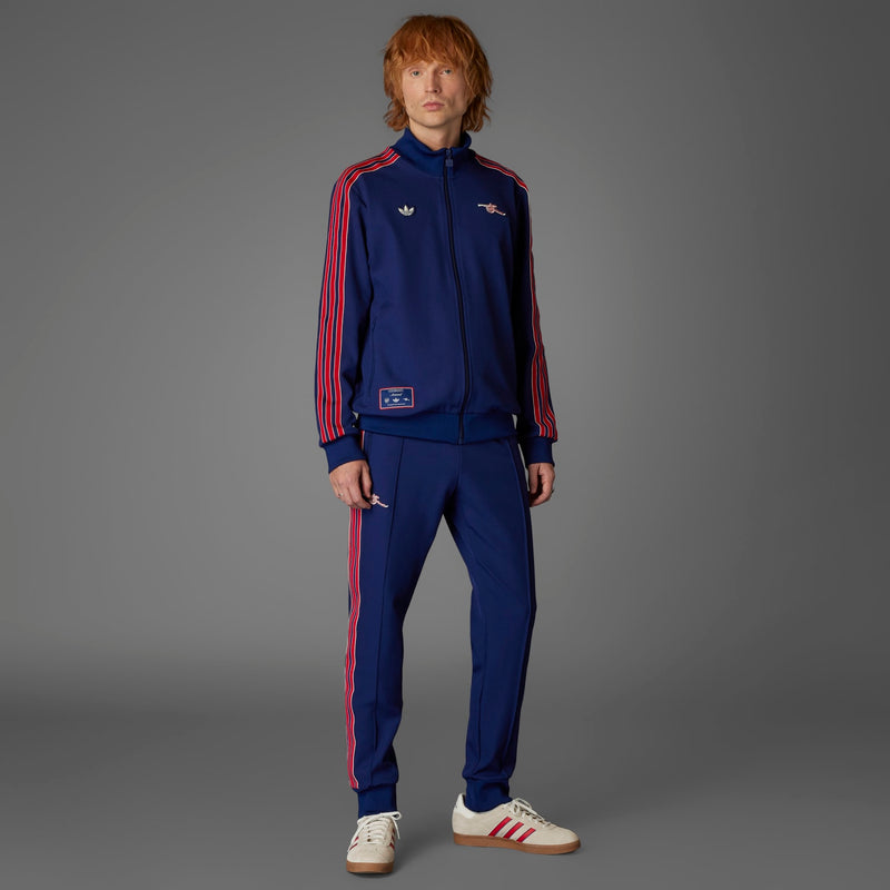 Men’s Arsenal-style blue track pants with red side stripes and zipper pocket