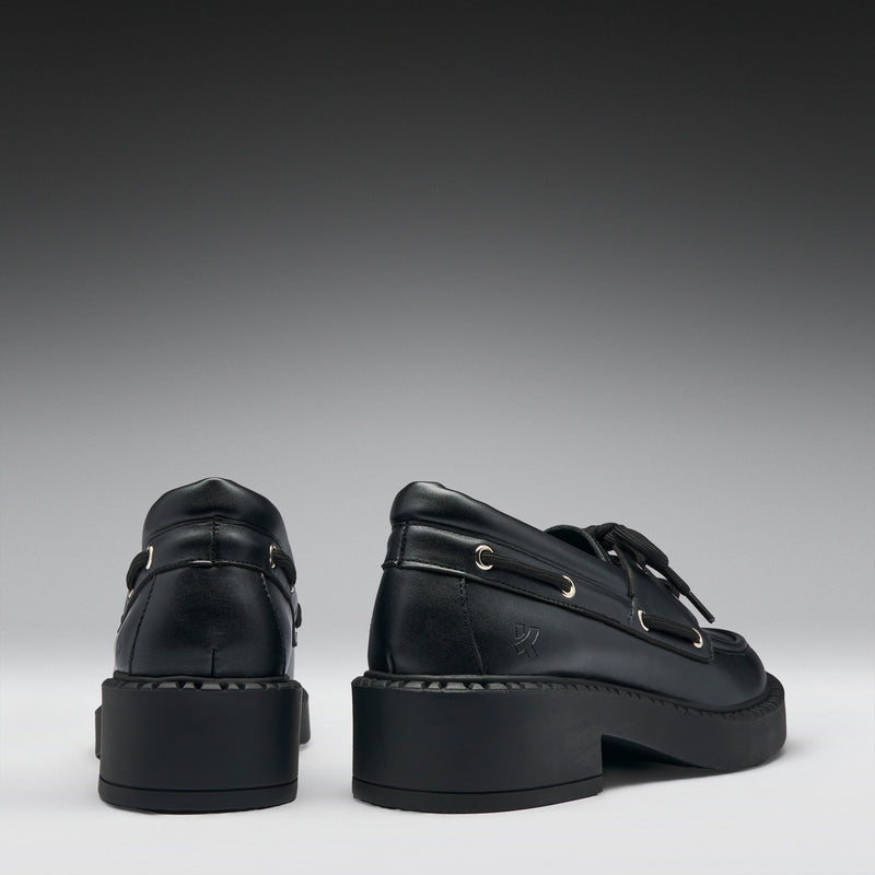 Pair of black leather shoes on a gray background