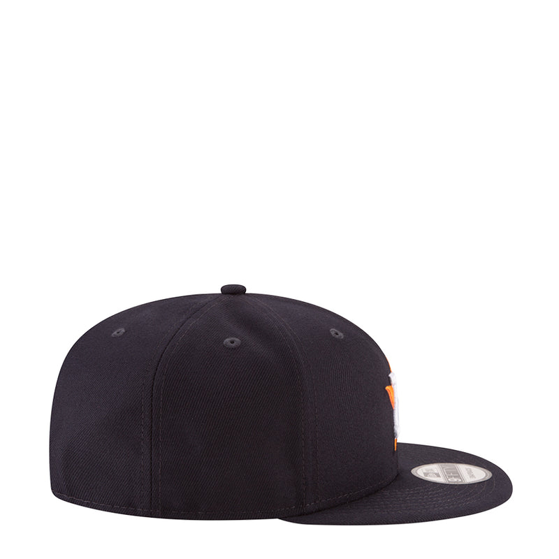 Navy baseball cap with curved brim and small orange side logo detail