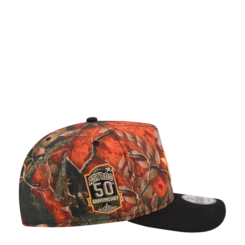 Two-tone baseball cap with orange camo leaves and side Astros 50 anniversary patch; black brim