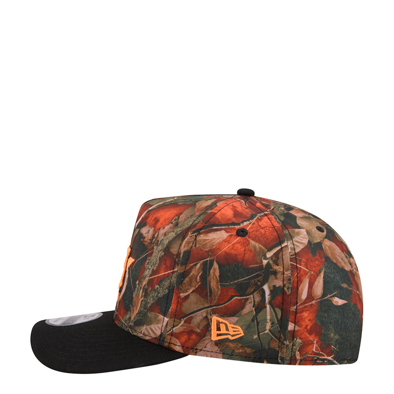 Two-tone baseball cap with orange camo leaf print and New Era logo on black brim