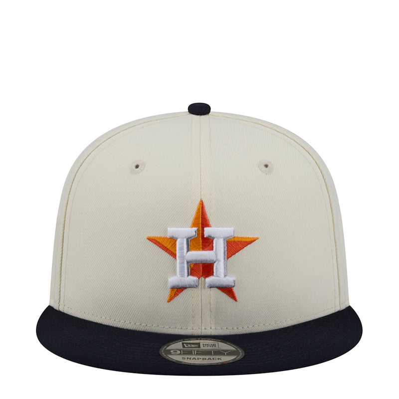 Two-tone baseball cap with orange-and-blue crest on white crown, navy brim