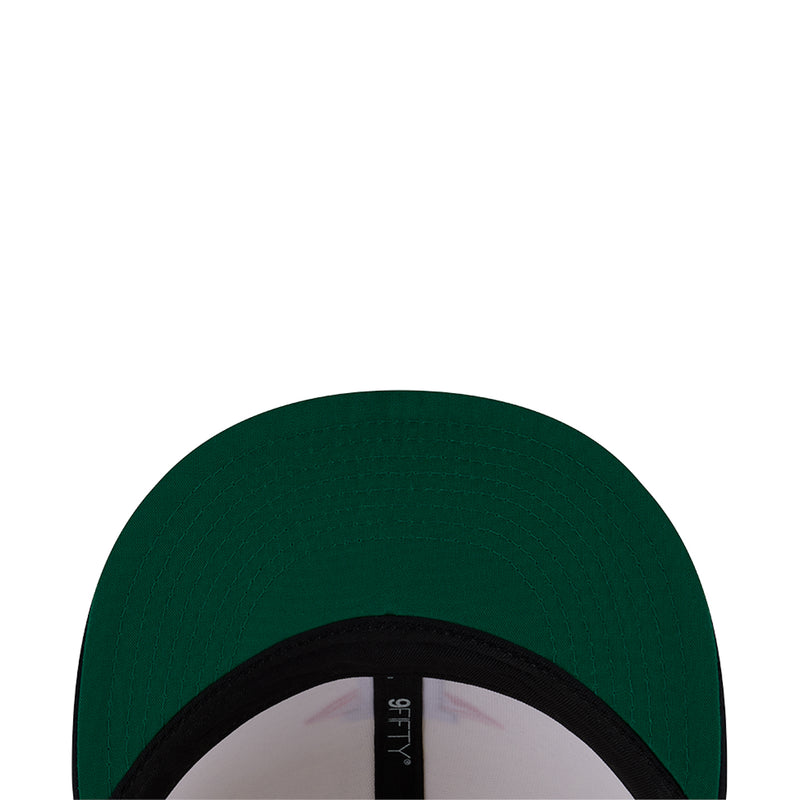 Baseball cap underside close-up with dark green fabric and black brim edge