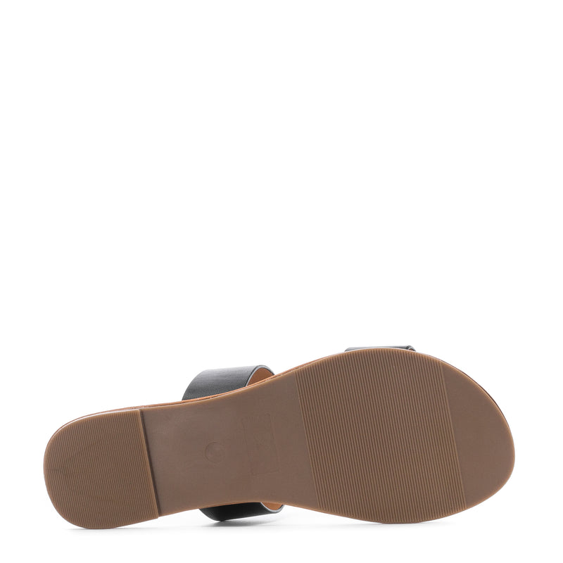 Women's black two-band slide sandal shown from bottom with ribbed tan outsole