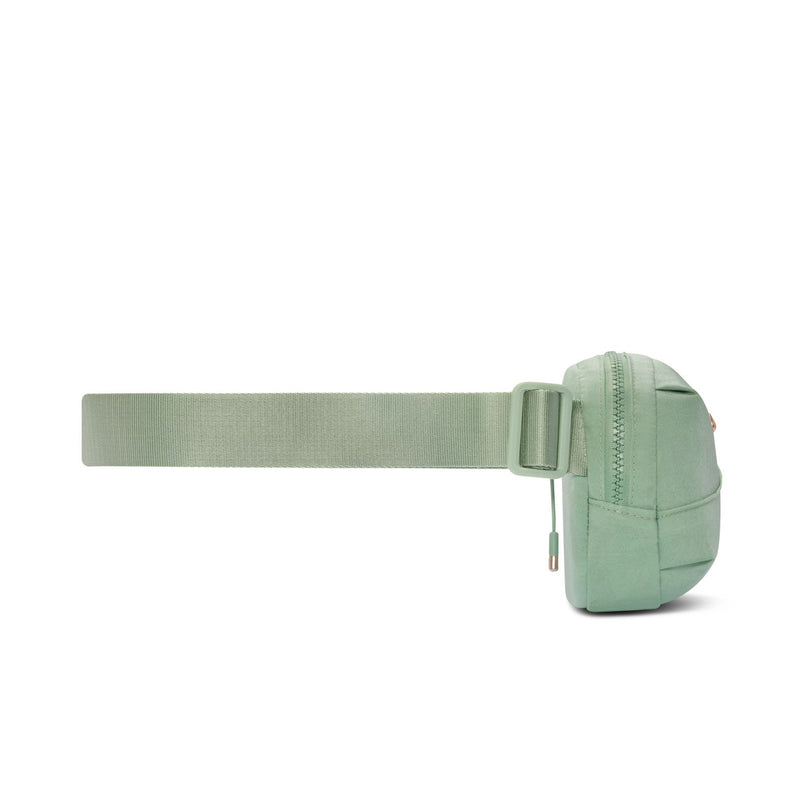 Light green Aura oval crossbody bag with wide webbing strap and zip closure