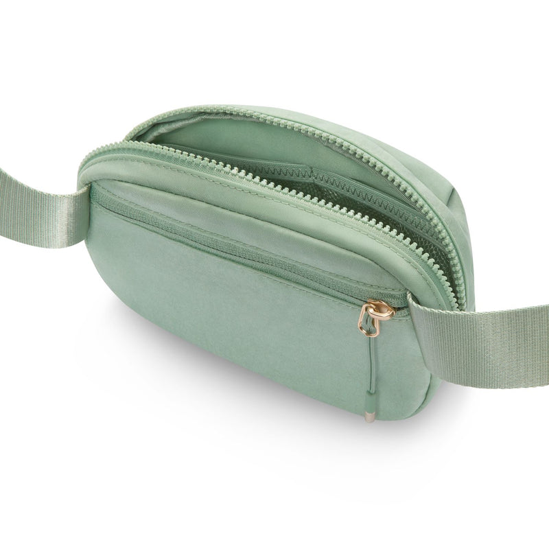 Light green Aura oval crossbody bag showing interior lining and double zip track