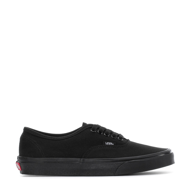 Black low-top canvas sneaker with lace-up closure and slim rubber sole