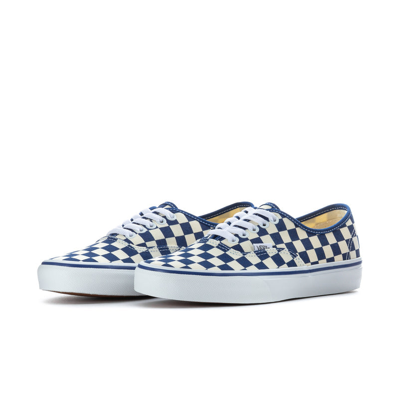 Pair of low-top blue and white checkerboard Vans sneakers with white laces