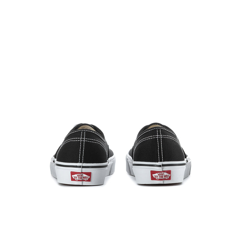 Men's black canvas sneakers, heel view with white midsole and red logo patch