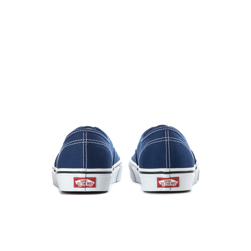Men's blue canvas low-top sneakers, rear view with heel patch and white soles