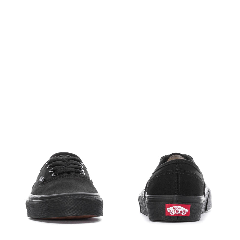Black youth low-top sneakers back view with Vans heel label and rubber sole