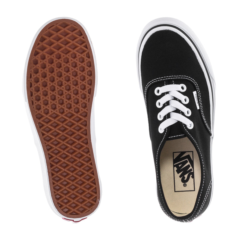 Black low-top sneaker with gum rubber outsole tread and Vans logo insole