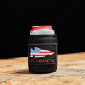 GORUCK black can koozie with American flag patch holding a beverage can on wooden table