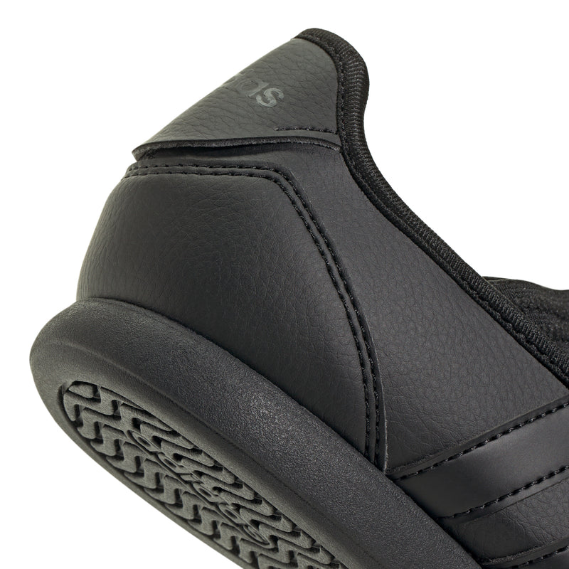 Close-up of youth Mary Jane heel, black upper with stitching and padded collar