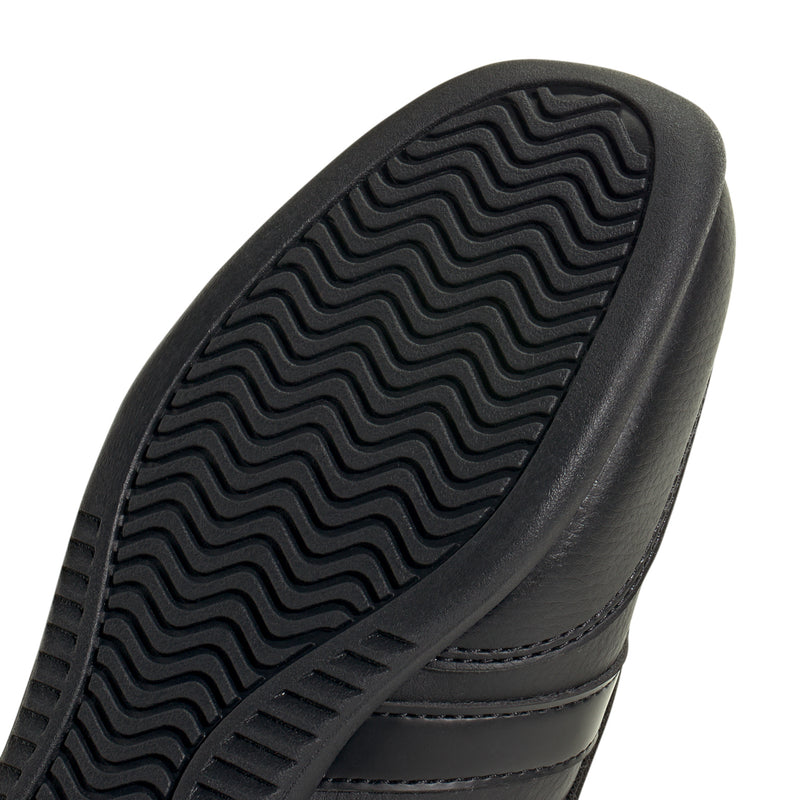 Close-up of youth Mary Jane outsole tread, black rubber traction pattern