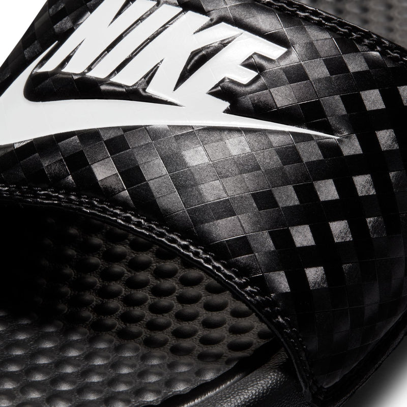 Close-up of black Nike checker-pattern upper and textured footbed