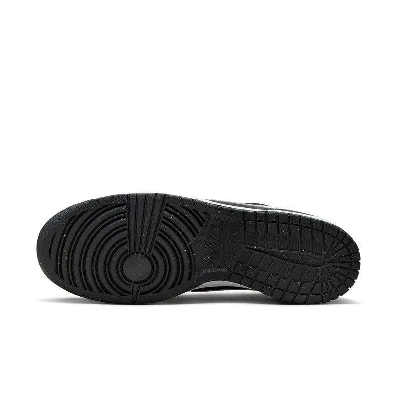Men's black low-top sneakers outsole view with traction tread and circular logo