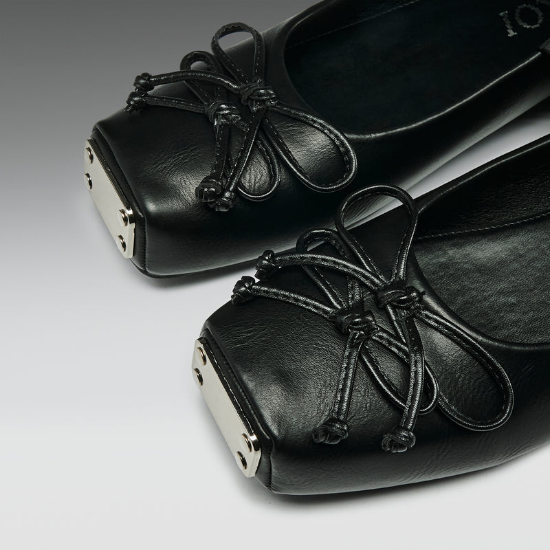 Black leather shoes with laces on a gray background
