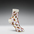White sock with colorful floral pattern on a gray background