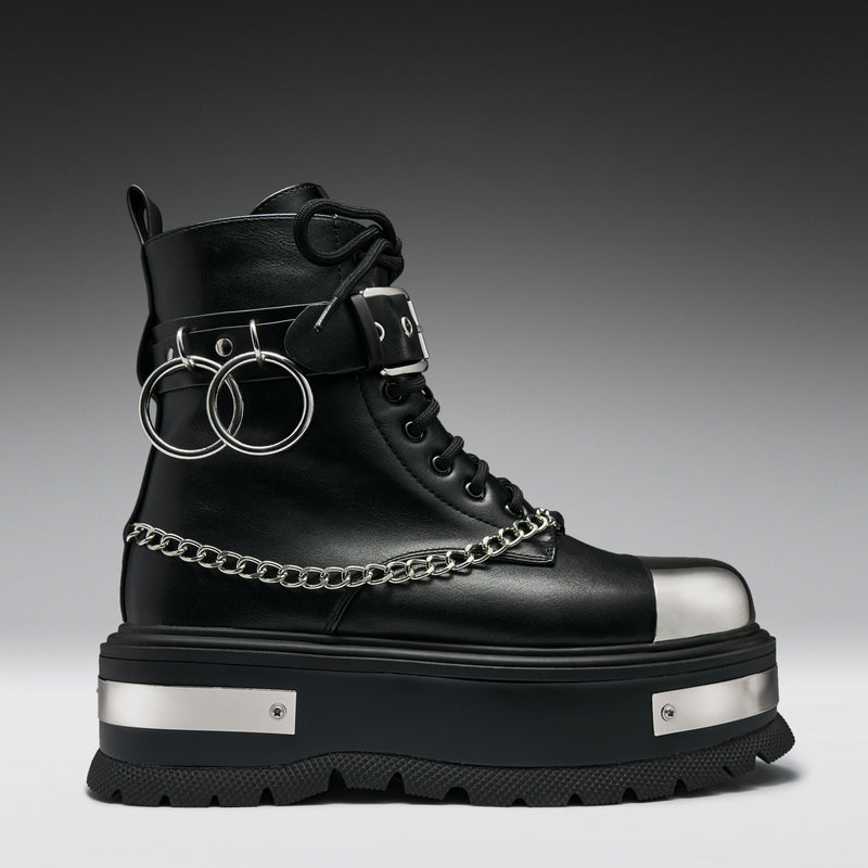 Black boot with silver chains and accents on a gradient background