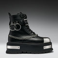 Black boot with silver chains and accents on a gradient background