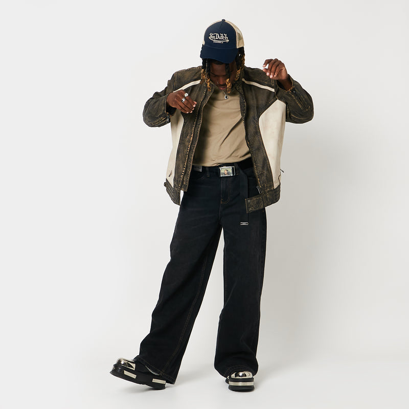 Male model wearing back high-top boots with chain details on a gradient background