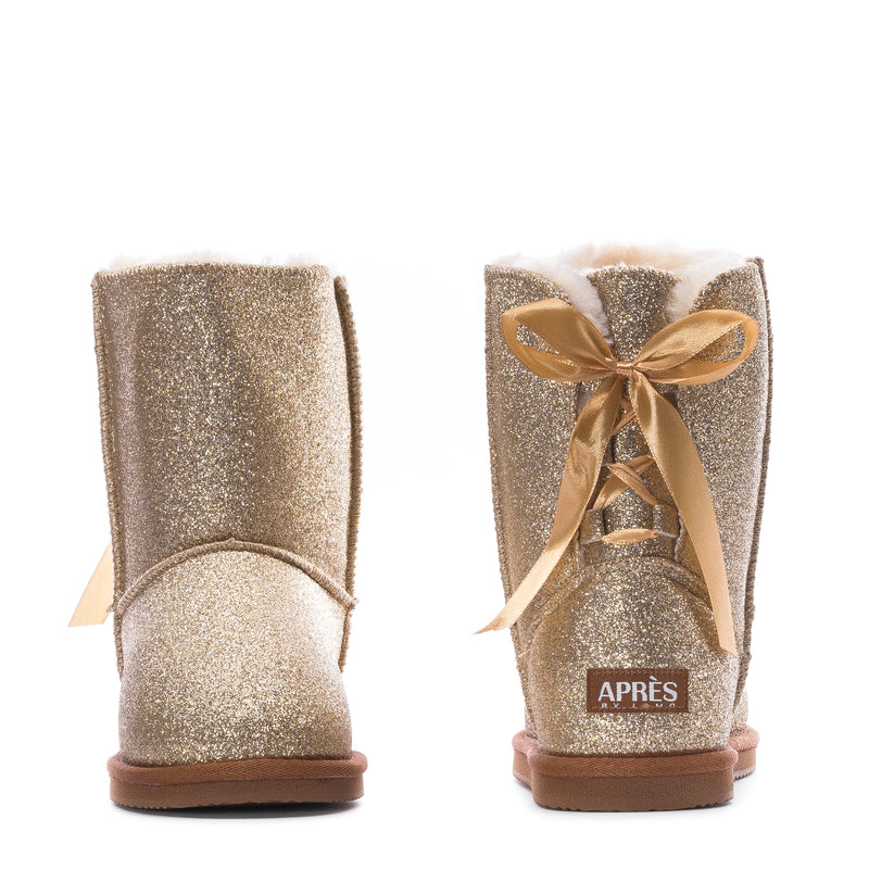 Pair of kids gold glitter boots with ribbon bow and “APRES” label on the back