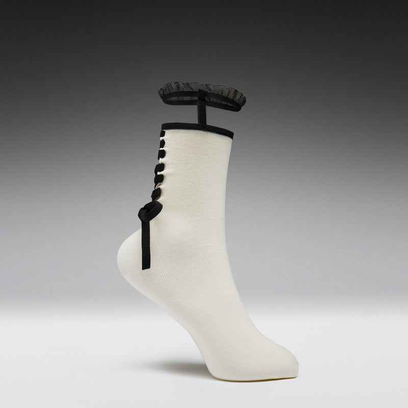 White sock with black decorative elements on a gray background