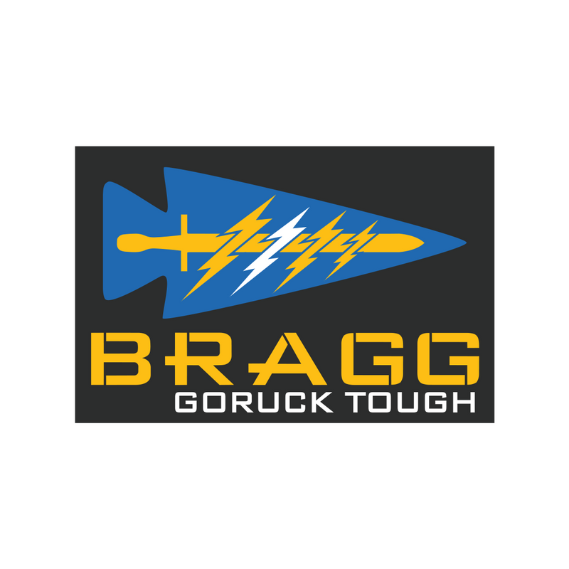 BRAGG 2027 features a blue spearhead with yellow and white lightning bolts, inspired by Special Forces training at Fort Bragg, above "BRAGG GORUCK TOUGH" in yellow on a black background.