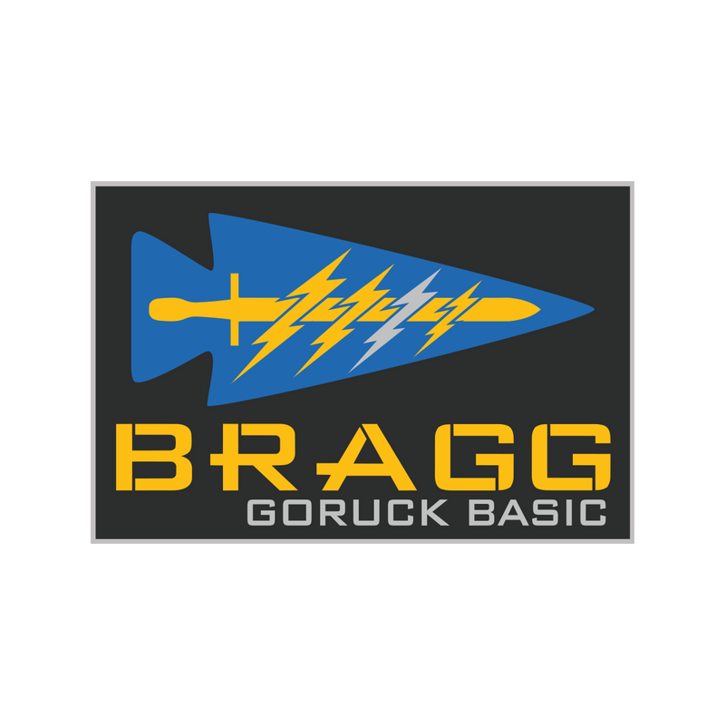 A blue spearhead with yellow lightning bolts above "BRAGG 2027" in bold yellow and white text, inspired by Fort Bragg’s Special Forces training.