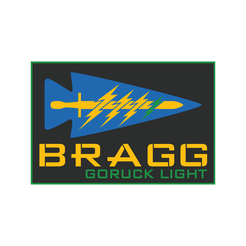 A blue arrowhead with yellow lightning bolts above "BRAGG 2027" in yellow text on a black background, inspired by Special Forces training at Fort Bragg.