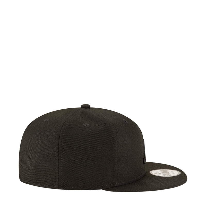 Black baseball cap side view with curved brim and circular label