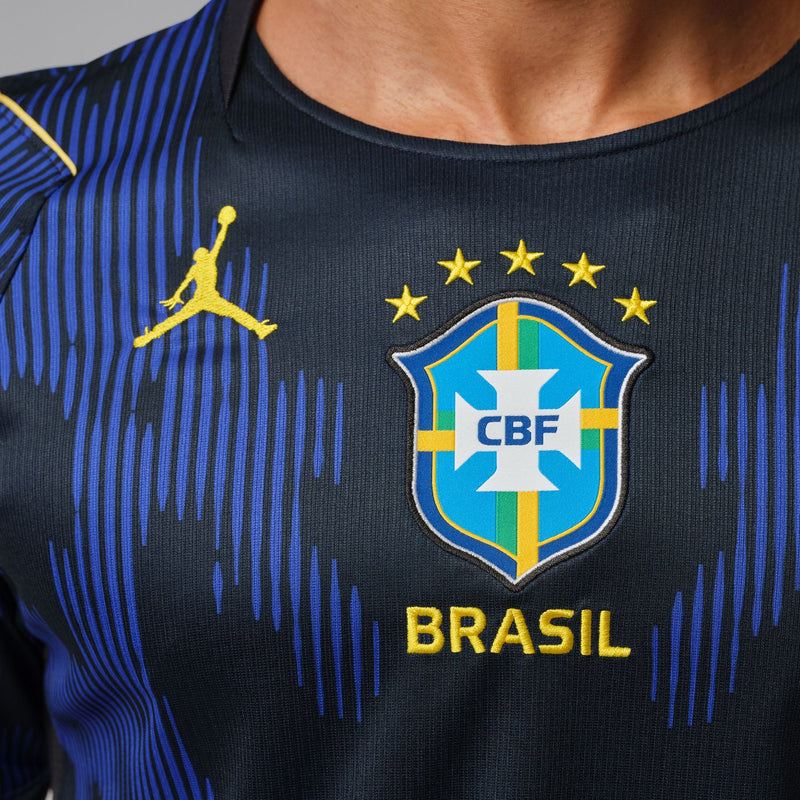 Brazil away soccer jersey chest panel with CBF crest, gold stars, and BRASIL lettering