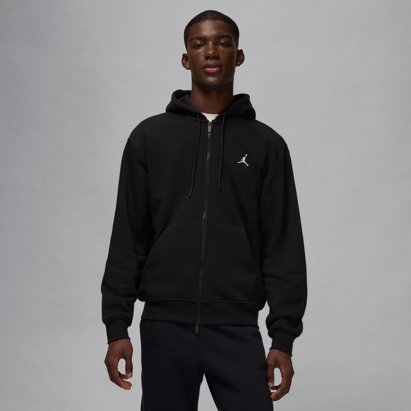 Black full-zip fleece hoodie on model, hood with drawstrings and Jordan logo.