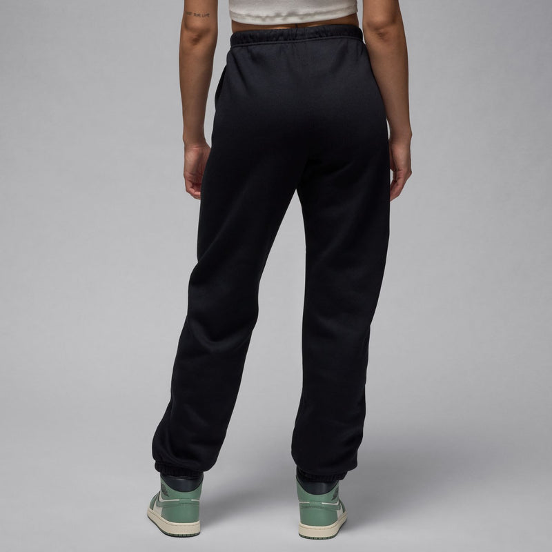 Women's black fleece sweatpants with elastic waistband and tapered legs