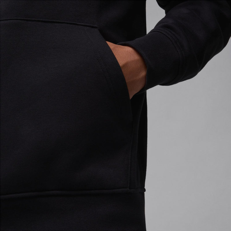 Black fleece pullover hoodie sleeve and kangaroo pocket detail