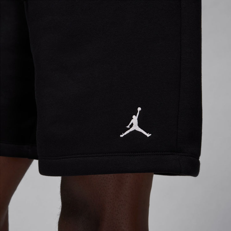 Men's black fleece shorts hem with side Jordan logo.