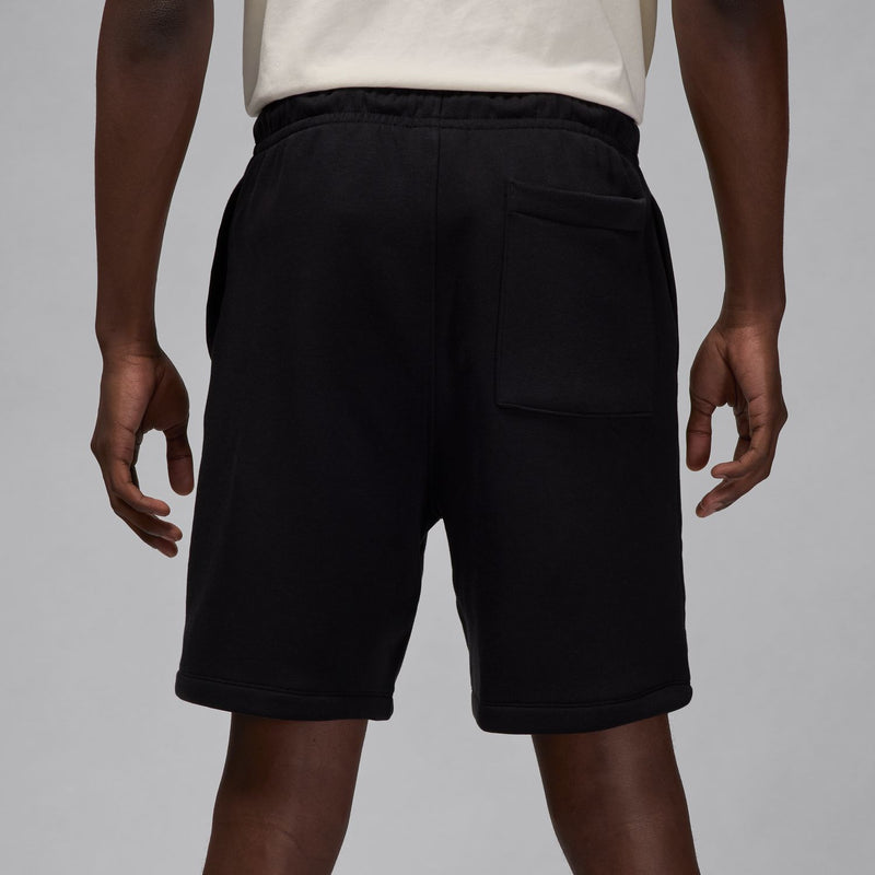 Men's black fleece shorts with front pockets and drawstring waistband.