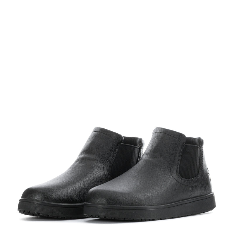 Pair of black leather chelsea boots with elastic side panels and thick tread sole